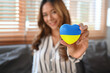 © Prathankarnpap - Woman hand holding heart with painted Ukraine flag..Concept of ending the war and pray for Ukraine.