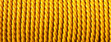 Yellow Rope Texture. Horizontal Panoramic Rolled Rope Background. Strong Line Looped In Coil.