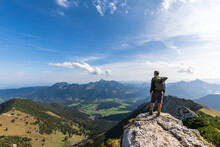 Male Hiker Admiring View From Summit Of Aiplspitz Mountain
