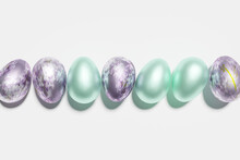 3d Render Of Shiny Blue And Violet Lilac Print Eggs On A White Background