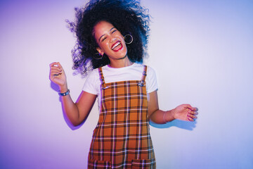 Vibrant young woman dancing and whipping her hair