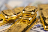 Fototapeta Londyn - pile of pure gold bars, bullion, ingot on background of US dollar banknotes