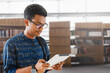© ProstoSvet - a student from india stands in the library and reads a list of references in his tablet
