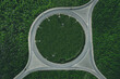 Aerial view of a traffic roundabout and road junctions in green forest
