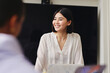 © Southworks - Portrait of cheerful mid adult Chinese businesswoman smiling in business meeting with confident expression