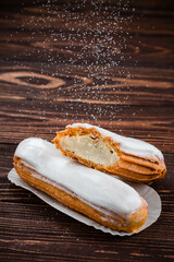 Wall Mural - Traditional french eclairs filled with vanilla cream and powdered sugar.