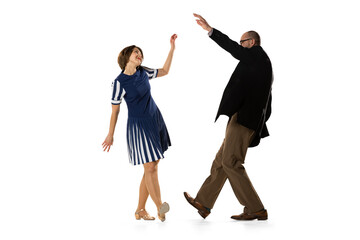 Wall Mural - Happy young man and woman in vintage retro style outfits dancing lindy hop dance isolated on white background. Timeless traditions, 60s, 70s fashion style.