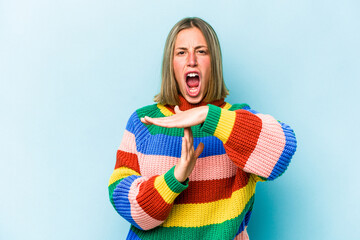 Wall Mural - Young caucasian woman isolated on blue background showing a timeout gesture.