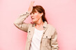 Middle age caucasian woman isolated on pink background forgetting something, slapping forehead with palm and closing eyes.