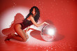 Young woman salsa dancer posing under a red projector's light