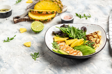 Assorted salad bowl lunch with grilled chicken, halloumi, avocado, green rocket salad, lime, sesame and seeds. Healthy food clean eating selection