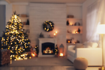 Canvas Print - Blurred view of stylish living room interior with decorated Christmas tree and comfortable sofa