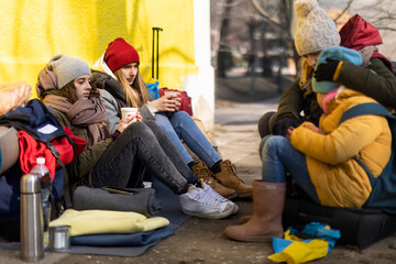 Wall Mural - Ukrainian immigrants crossing border and sitting and waiting for registration.