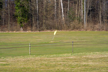 Driving Range At City Of Zürich With Flag And Golf Balls On A Sunny Spring Day. Photo Taken March 1st, 2022, Zurich, Switzerland.
