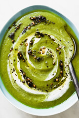 Wall Mural - Green broccoli soup with coconut milk and fried hot spices on marble table