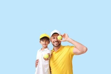 Poster - Little boy and his trainer with tennis balls on blue background