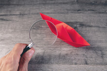 Magnifying Glass And Paper Boats On The Table