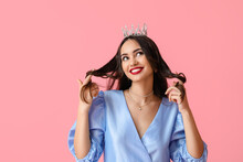 Beautiful Young Woman In Stylish Dress And Tiara On Pink Background
