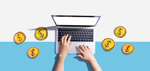 Person using a laptop computer with coins - earn online - work from home themes