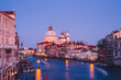 Filtred scenery landscape with lights on water of Grand Canal during evening time for romantic sightseeing in Venezia, overview of ancient architecture buildings during international vacations