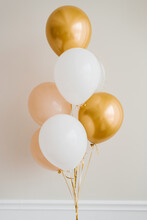 Festive Balloons In Gold, Pink And White In A Bouquet