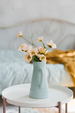 Artificial Poppy Flowers In A Blue Vase In The Form Of A Jug On The Coffee Table In The Interior Of The Room