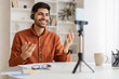 © Prostock-studio - Arab man having videocall using cellphone on tripod
