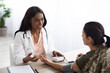 © Prostock-studio - Black Doctor Woman Consulting Female Soldier And Checking Her Blood Pressure