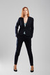 © boomeart - Stylish middle aged woman in pantsuit posing in studio