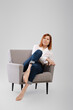 © boomeart - Middle age woman relax in cozy armchair