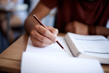 Developing Good Study Habits. Closeup Shot Of A Young Student Writing On A Note Pad.