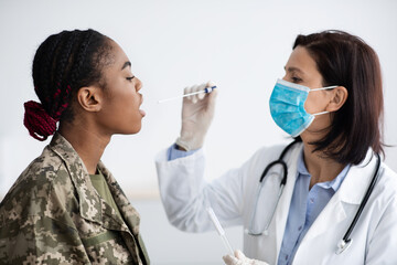 PCR Coronavirus Test. Doctor Taking Swab From Black Military Female's Mouth