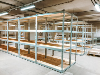 An empty building prepares for a new retail store opening with a large area for selling goods, there will be many buyers, rented properties, construction of a store for shopping,empty shelving