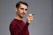 © SHOTPRIME STUDIO - handsome man in a sweater with pen posing emotions business and office concept
