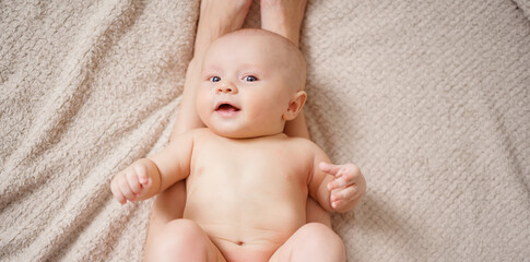 Sticker - cute naked baby lies on his mother's feet. maternal and child health. 