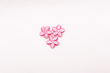 pink floral textile patches for clothes customization, isolated on white.