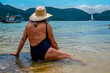 Senior woman with hat on the beach. Ilha Grande, Angra dos Reis - State of Rio de Janeiro, Brazil.