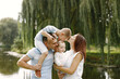 © hetmanstock2 - Happy family resting in park near the lake
