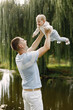 © hetmanstock2 - Young father throwing his little daughter up in the air