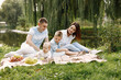 © hetmanstock2 - Happy family have a picnic in park near the lake