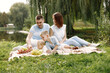 © hetmanstock2 - Happy family resting in park near the lake