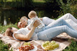 © hetmanstock2 - Happy family have a picnic in park near the lake