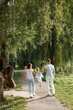 © hetmanstock2 - Back view photo of a family walking in a park on summer