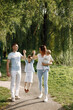 © hetmanstock2 - Photo of a family walking in a park on summer