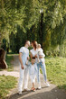 © hetmanstock2 - Photo of a family walking in a park on summer