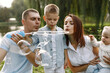© hetmanstock2 - Happy family blowing a soap bubbles in park near the lake