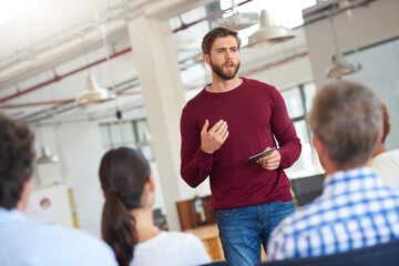 Wall Mural - Speak with confidence. Shot of designer giving a presentation to his colleagues using a digital tablet.