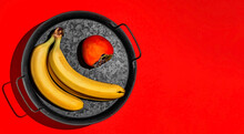 Ripe Bananas And Juicy Persimmons On A Metal Tray, Layout On A Bright Red Background With Copy Space, Minimal Style Mockup. Delicious Healthy Fruits For Breakfast