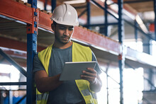 Get All The Info Where And When You Need It. Shot Of A Builder Using A Digital Tablet While Working At A Construction Site.