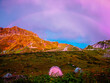 Tourist tents in the mountains of Krasnaya Polyana (Sochi) in summer. A rainbow in the sunset sky. 